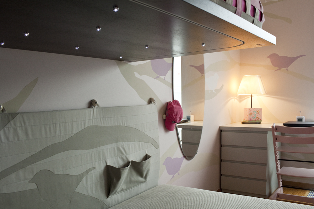 Textilní dekorace a nástěnné malby byly vytvořeny speciálně pro tento projekt. Motiv ptáčka se v různých odstínech opakuje v celé místnosti.